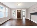 Bright living room featuring hardwood floors, large windows, a decorative fireplace, and an open floor plan at 1337 Linden St, Indianapolis, IN 46203