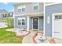 Close up of the front porch with muted blue siding, white trim, and a welcoming black door at 13872 N Mardenis W Dr, Camby, IN 46113