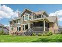 Spacious backyard with well-maintained lawn, covered patio, and appealing exterior at 14747 Harvest Glen S Blvd, Fishers, IN 46037
