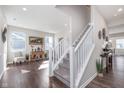 Open entryway showcasing hardwood floors, a staircase with white railing, and access to a living space at 1695 Jackson St, Fortville, IN 46040