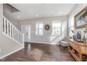 Bright living room featuring hardwood floors, modern decor, and large windows for plenty of natural light at 1695 Jackson St, Fortville, IN 46040