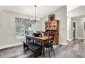 Inviting dining room with wood table, chandelier and modern wood flooring at 2143 Sunderland Dr, Martinsville, IN 46151