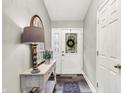 Bright foyer with stylish console table, decor, and wood-look floors at 2143 Sunderland Dr, Martinsville, IN 46151