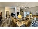 Spacious living room with vaulted ceiling, fireplace, ceiling fan, and neutral color scheme at 2143 Sunderland Dr, Martinsville, IN 46151