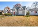 Charming two-story gray home with red door, well-kept lawn, and surrounding residential neighborhood at 2309 Pearl St, Columbus, IN 47201