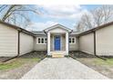 Inviting front entrance features a blue door, stone accents, and a gravel pathway at 2420 Goose Creek Rd, Martinsville, IN 46151