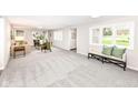 Bright and airy living room featuring plush carpeting and neutral decor at 2420 Goose Creek Rd, Martinsville, IN 46151