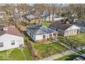 An aerial shot shows a compact house with a simple roof, surrounded by a small yard at 2429 N Arsenal Ave, Indianapolis, IN 46218