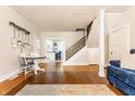 Bright living room with hardwood floors and staircase at 310 W Staat St, Fortville, IN 46040