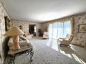 Spacious living room featuring patterned wallpaper, neutral carpet, and large windows at 3395 State Road 44, Martinsville, IN 46151
