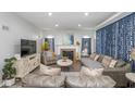 Cozy living room with a fireplace, comfortable seating, and stylish blue curtains at 3636 N Chester Ave, Indianapolis, IN 46218