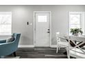 Bright entryway with stylish flooring, a glass table set, and a cozy teal chair at 3712 N Olney St, Indianapolis, IN 46218