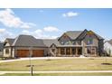 Beautiful two-story home showcasing a three-car garage and inviting front porch at 3899 Chapel Hill Ct, Bargersville, IN 46106