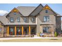 Inviting front porch with wooden posts, comfortable seating, and decorative accents at 3899 Chapel Hill Ct, Bargersville, IN 46106
