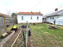 Spacious backyard with garden beds, fire pit, and ample space for outdoor activities at 3949 Fletcher Ave, Indianapolis, IN 46203