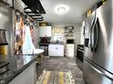 Modern kitchen with stainless steel appliances, granite countertops, and ample cabinet space at 3949 Fletcher Ave, Indianapolis, IN 46203