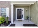 Charming front porch featuring a stylish black door and attractive landscaping at 4363 Rhapsody Ln, Indianapolis, IN 46235