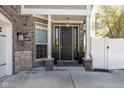 Elegant front entrance with black door, decorative columns, and potted plants for added curb appeal at 445 W 86Th St, Indianapolis, IN 46260