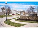 Community entrance sign at Wolf Run with stone base surrounded by landscaped lawn and neighborhood homes at 4846 Shakamak Ct, Indianapolis, IN 46239