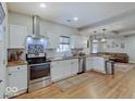 Modern kitchen with white cabinets, stainless steel appliances, and butcher block countertops at 501 W Pearl St, Trafalgar, IN 46181