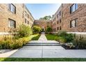 Beautiful courtyard view between brick apartment buildings with manicured landscaping at 5347 N College Ave # Apt 109, Indianapolis, IN 46220