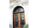 Elegant wooden front door with decorative ironwork and stone surround at 5347 N College Ave # Apt 109, Indianapolis, IN 46220