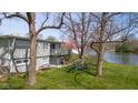 Scenic backyard featuring a large deck, picnic area, and playground with lake view at 601 Terrace Lake Dr, Columbus, IN 47201