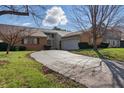 Traditional single-Gathering home featuring brick accents, an attached garage, and a curved driveway at 6140 Buttonwood Dr, Noblesville, IN 46062