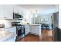 Modern kitchen with white cabinets, subway tile backsplash, and stainless steel appliances at 6555 Michigan Rd, Indianapolis, IN 46268