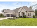 Elegant brick home featuring manicured landscaping, a three-car garage, and a charming front entrance at 7259 Josiah Ct, Indianapolis, IN 46259