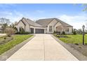 Beautiful white brick home with a spacious driveway, lush lawn, and professional landscaping at 7259 Josiah Ct, Indianapolis, IN 46259