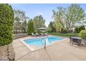 Backyard pool area complete with lounge seating, dining table, mature landscaping, and recreation space at 7259 Josiah Ct, Indianapolis, IN 46259