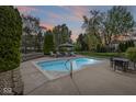 In-ground pool in a backyard with a patio, lounge chairs, and an umbrella at 7259 Josiah Ct, Indianapolis, IN 46259