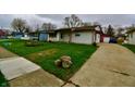 Cozy single-story home with a convenient driveway leading to a detached garage at 7367 Parkside Dr, Indianapolis, IN 46226