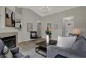 Bright living room featuring vaulted ceilings, fireplace, and modern decor at 7783 Park N Ct, Indianapolis, IN 46260
