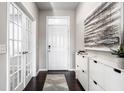 Bright foyer featuring dark floors, white walls, and an accent wall with decorative art at 8405 Whitaker Valley Blvd, Indianapolis, IN 46237