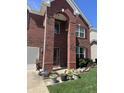 Charming two-story brick home with manicured lawn and flower beds at 8744 N Aspen Way, McCordsville, IN 46055