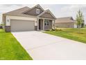 Well-maintained home boasts a concrete driveway, lush green lawn, and inviting covered porch at 895 Saddlebrook Farms Blvd, Whiteland, IN 46184