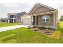 Attractive home showcases a mix of brick and siding, a neat lawn, and an attached two-car garage at 895 Saddlebrook Farms Blvd, Whiteland, IN 46184