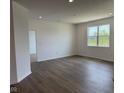 Open-concept living room with hardwood floors and a large window providing ample natural light at 895 Saddlebrook Farms Blvd, Whiteland, IN 46184