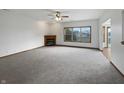Spacious living room showcasing a fireplace and a large window offering plenty of natural light at 9237 Stones Ferry Pl, Indianapolis, IN 46278