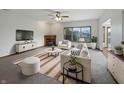 Bright and airy living room featuring a fireplace, large window, and stylish neutral furniture at 9237 Stones Ferry Pl, Indianapolis, IN 46278