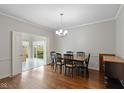 Formal dining room with hardwood floors, chandelier, and access to a sunroom at 9544 Huntington Ln, Indianapolis, IN 46260