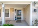 Inviting covered front porch with a decorative glass front door and stylish exterior lighting at 9705 Shasta Dr, Fishers, IN 46038