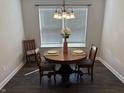 Dining room featuring an elegant chandelier, round table, and natural light at 10869 Spirit Dr, Ingalls, IN 46048