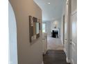 Inviting hallway with hardwood floors leading to a cozy living room with a fireplace at 10869 Spirit Dr, Ingalls, IN 46048