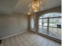 Bright entryway featuring tile floors, a decorative light fixture, and a large window at 11147 Autumn Creek Ct, Indianapolis, IN 46229