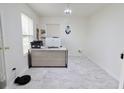 Home office with bright natural light, modern desk setup, and marble-like flooring at 11149 Titania Ct, Noblesville, IN 46060