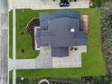 Aerial view of a meticulously maintained home with a dark roof, spacious yard, and inviting outdoor deck at 11640 Ansley Ct, Zionsville, IN 46077