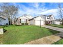 Inviting single-story home with lush green lawn, brick accents, and attached two-car garage, offering curb appeal at 12030 Driftstone Dr, Fishers, IN 46037